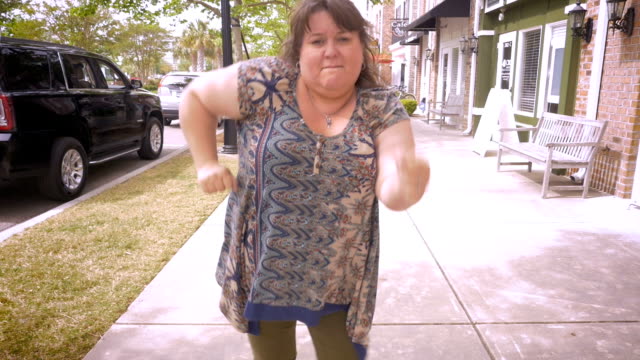 A-crazy-plus-sized-woman-dancing-in-the-streets-celebrating-achievement
