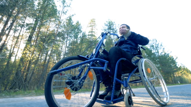 One-man-drives-on-a-medical-bicycle,-bottom-view.