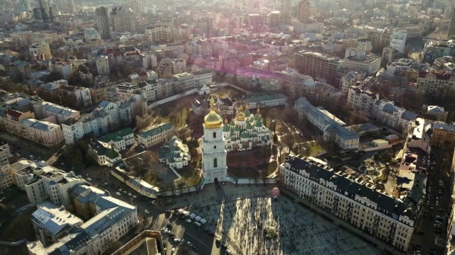 A-bird's-eye-view,-panoramic-video-from-the-drone-in-FullHD-to-the-Saint-Sophia's-Cathedral,-Sofiyivska-Square-in-the-city-of-Kiev,-Ukraine.-People-on-the-square-on-Easter-days.