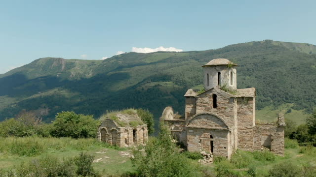 Departure-on-a-drone-from-the-ancient-dilapidated-Christian-church-standing-high-on-the-mountain.-Aerial-View.-North-Caucasus.-Russia