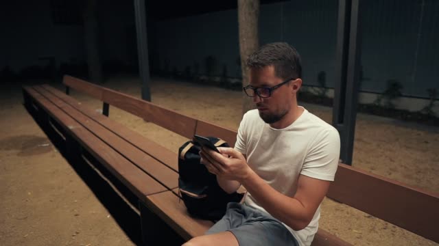 Guy-alone-in-evening-with-smartphone.
