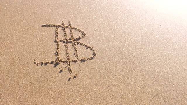 Signo-de-Bitcoin-escrito-en-la-arena-del-mar.-Las-ondas-lavaron-la-inscripción.