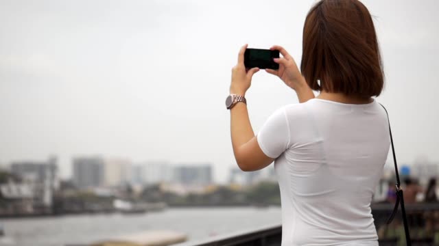 Beautiful-young-asian-woman-using-smartphone-take-photo.-Beautiful-asian-girl-tourist-travel-to-thailand.