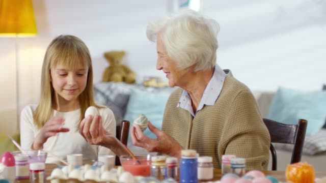 Adorable-Girl-Preparing-for-Easter-with-Grandmother