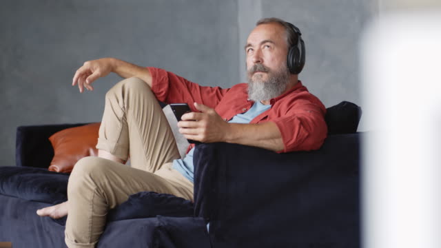 Aged-Man-Resting-on-Sofa-at-Home