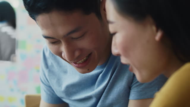 Handheld-view-of-couple-have-fun-while-using-mobile-phone