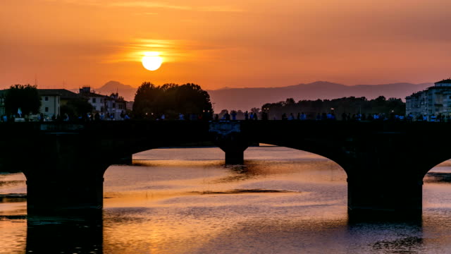Stadtansicht-Blick-auf-Fluss-Arno-mit-berühmten-Heiligen-Dreifaltigkeit-Brücke-Zeitraffer-auf-den-Sonnenuntergang-in-Florenz