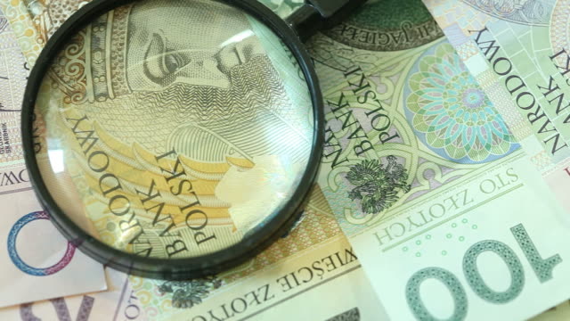 Banknotes-with-magnifying-glass