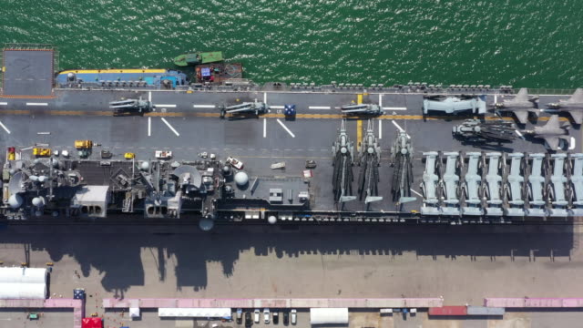 4K,-Aerial-top-view-USA-aircraft-carrier-warship-transportation-fighter-plane,-helicopter,-tank,-battleship.