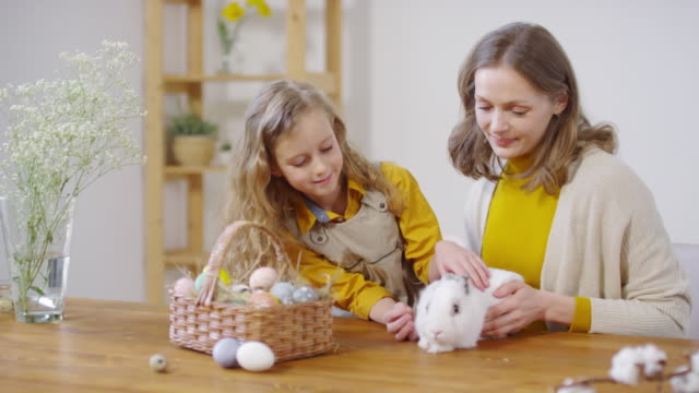 Woman-and-Girl-Petting-Cute-Bunny-at-Easter