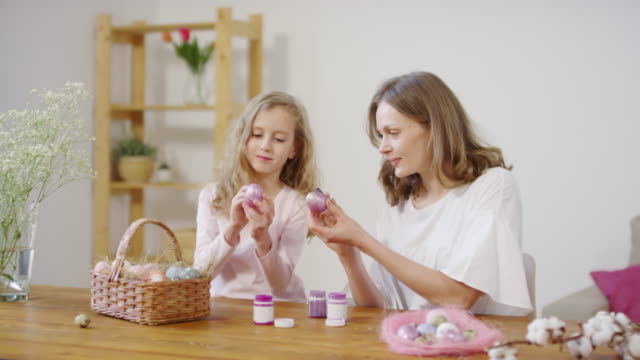 Mother-and-Daughter-Putting-Glitter-Paint-on-Easter-Eggs