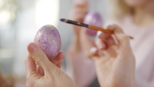 Unrecognizable-Woman-Putting-Glitter-on-Easter-Egg