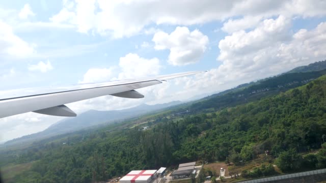 hilly-landscape-under-blue-sky-view-from-taking-off-plane