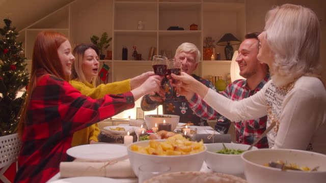 Big-family-dinner-evening-wine-toast-clink-glasses-alcohol-dinner-christmas-reunion-christmas