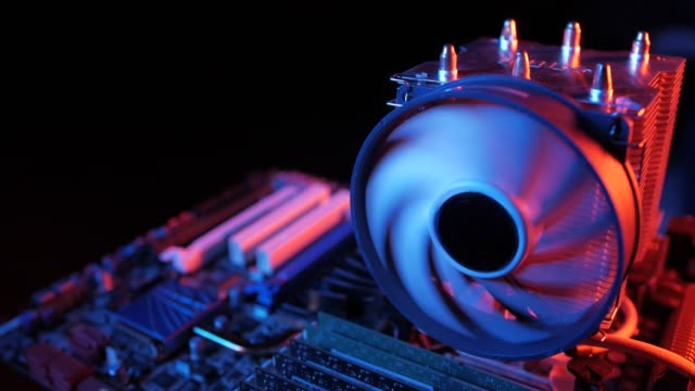 closeup-of-a-rotating-processor-CPU-fan-installed-on-the-motherboard-on-a-black-background