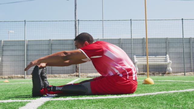 Soccer-player-stretching-on-the-field