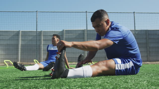 Soccer-players-stretching-on-field