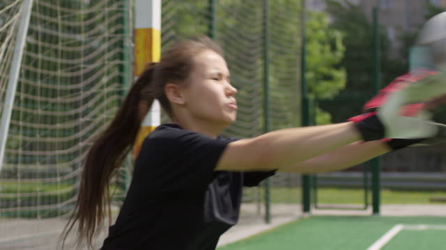 Young-Female-Goalkeeper-defending-the-Goal-during-Soccer-Training
