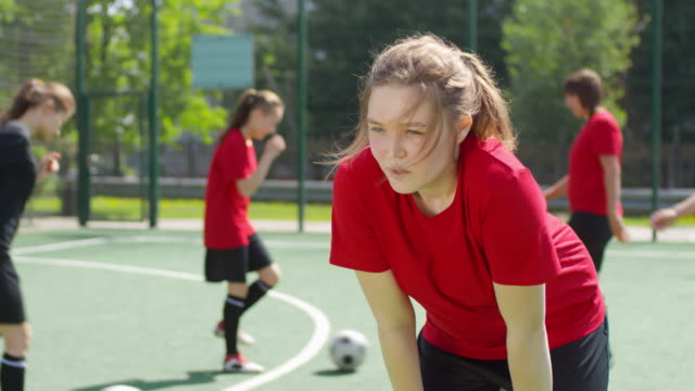 Teenage-Girl-Ruht-nach-Fußballtraining