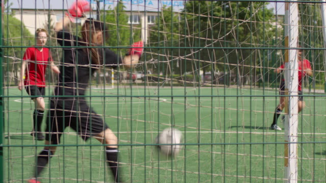 View-through-Soccer-Net-of-Female-Goalkeeper-Trying-to-Make-a-Save