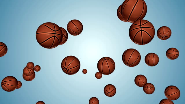 Basketballs-flying-in-slow-motion-against-blue-gradient