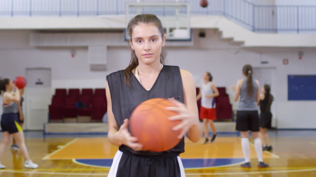 Joven-hermosa-jugador-actriz-posando-con-baloncesto-para-la-cámara