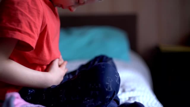 little-boy-is-holding-his-hands-to-his-stomach-and-writhing-in-pain.-abdominal-pain-in-a-child.