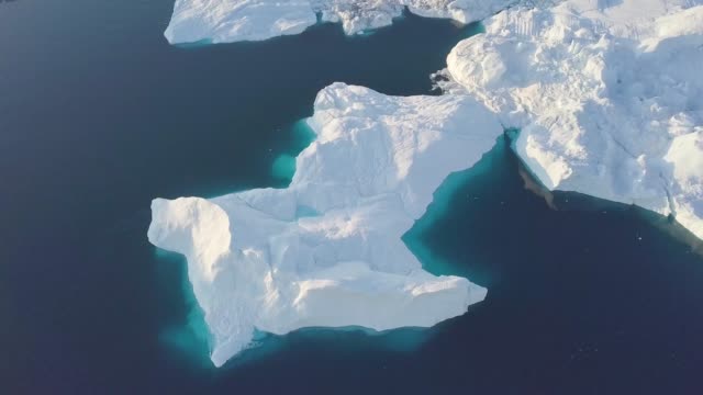 Icebergs-drone-aerial-video-top-view---Climate-Change-and-Global-Warming---Icebergs-from-melting-glacier-in-icefjord-in-Ilulissat,-Greenland.-Arctic-nature-ice-landscape-in-Unesco-World-Heritage-Site.