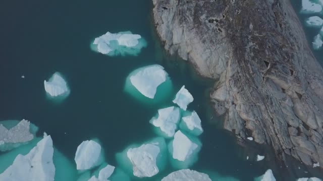 Icebergs-drone-aerial-video-top-view---Climate-Change-and-Global-Warming---Icebergs-from-melting-glacier-in-icefjord-in-Ilulissat,-Greenland.-Arctic-nature-ice-landscape-in-Unesco-World-Heritage-Site.