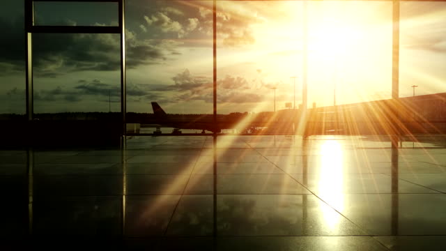 Silhouettes-of-passengers-at-the-airport-during-sunset