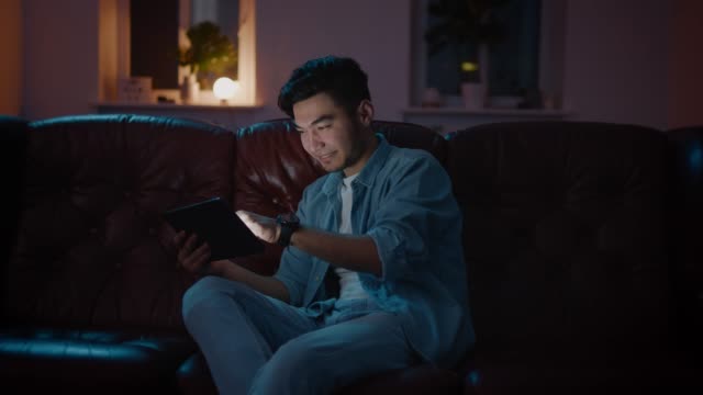 Joyful Asian Boyfriend And Girlfriend Playing Video Game At Home