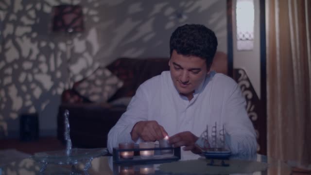 Children-move-secretly-as-their-father-lights-up-candles-for-Eid-festival