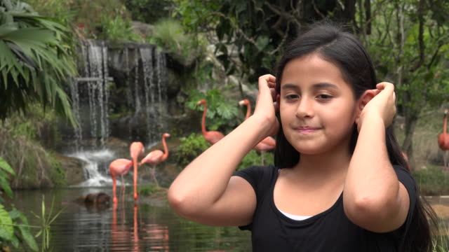 Girl-near-Waterfall-and-Flamingos