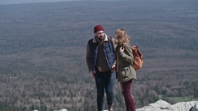 Couple-Checking-Direction-on-Phone-during-Hiking-Trip