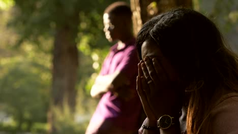 African-couple-after-arguing-in-the-park.-Silence,sadness,cry