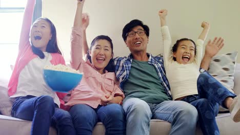 Excited-family-watching-television-together-in-living-room-4k