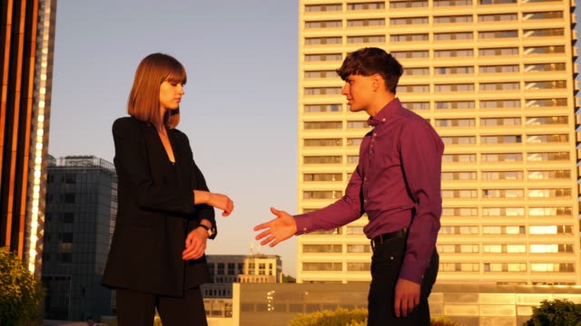 young-business-woman-rejects-man-handshake