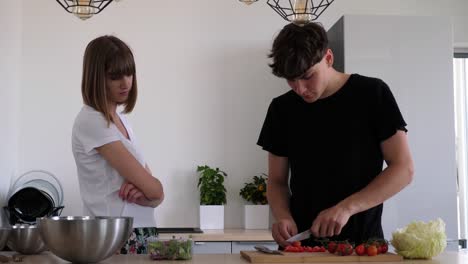 Young-couple-arguing-while-making-a-vegetable-meal,-woman-gets-angry,slow-motion
