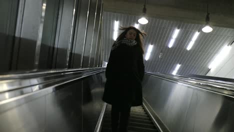 Woman-descending-on-modern-electric-escalator-stairs.-Girl-walking-down-staircases-in-4K