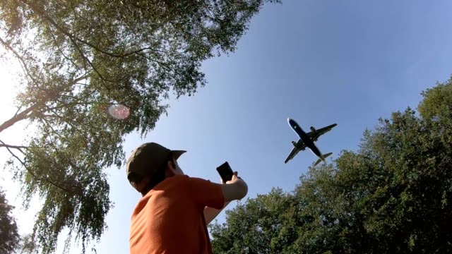 Airplane-flies-over-a-boy-on-landing