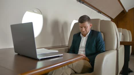 Businessman-chat-and-sit-in-armchair-in-private-jet