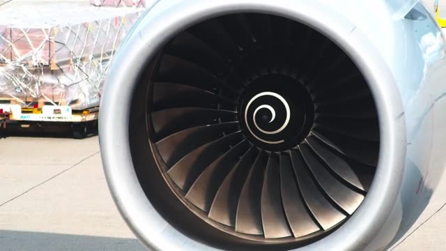 Airplane-turbo-engine-blades-fan-on-the-right-wing-and-test-moving-before-take-off-for-long-flight-to-Japan