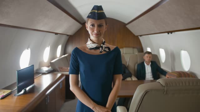 Cabin-hostess-applause-to-camera-inside-of-private-business-jet
