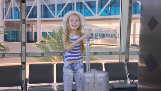 Teenager-girl-with-travel-suitcase-waiting-airplane-in-departure-lounge-in-airport