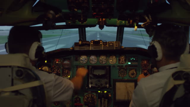 Pilots-in-Cockpit-Controlling-Airplane