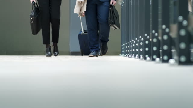 People-in-suits-going-in-terminal