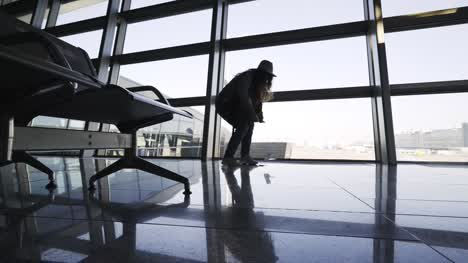Frau-Smartphone-auf-Flughafen-Boden-fallen-zu-lassen