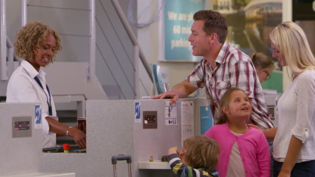 Family-Going-On-Vacation-Checking-In-At-Airport-Shot-On-R3D