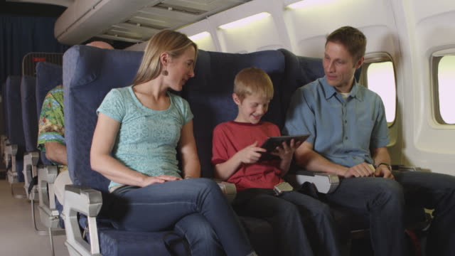 Family-using-tablet-on-plane