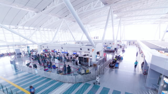 Airport-time-lapse,-passengers-walking-around-in-terminal